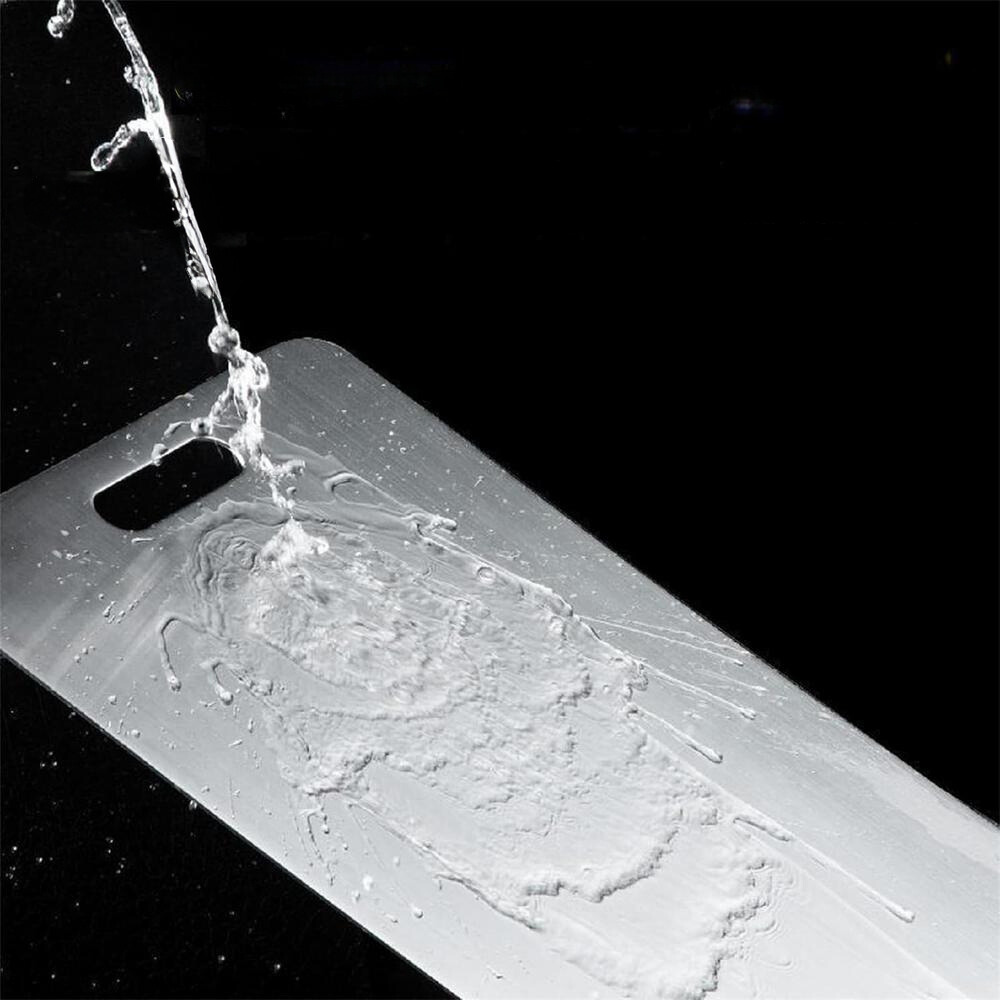 Phone case with water splashing onto it against a black background