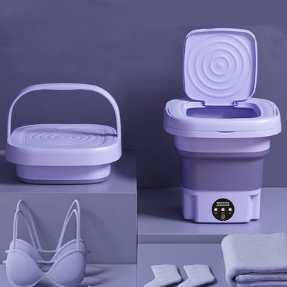 Collapsible purple washing machine with accessories on a matching purple background